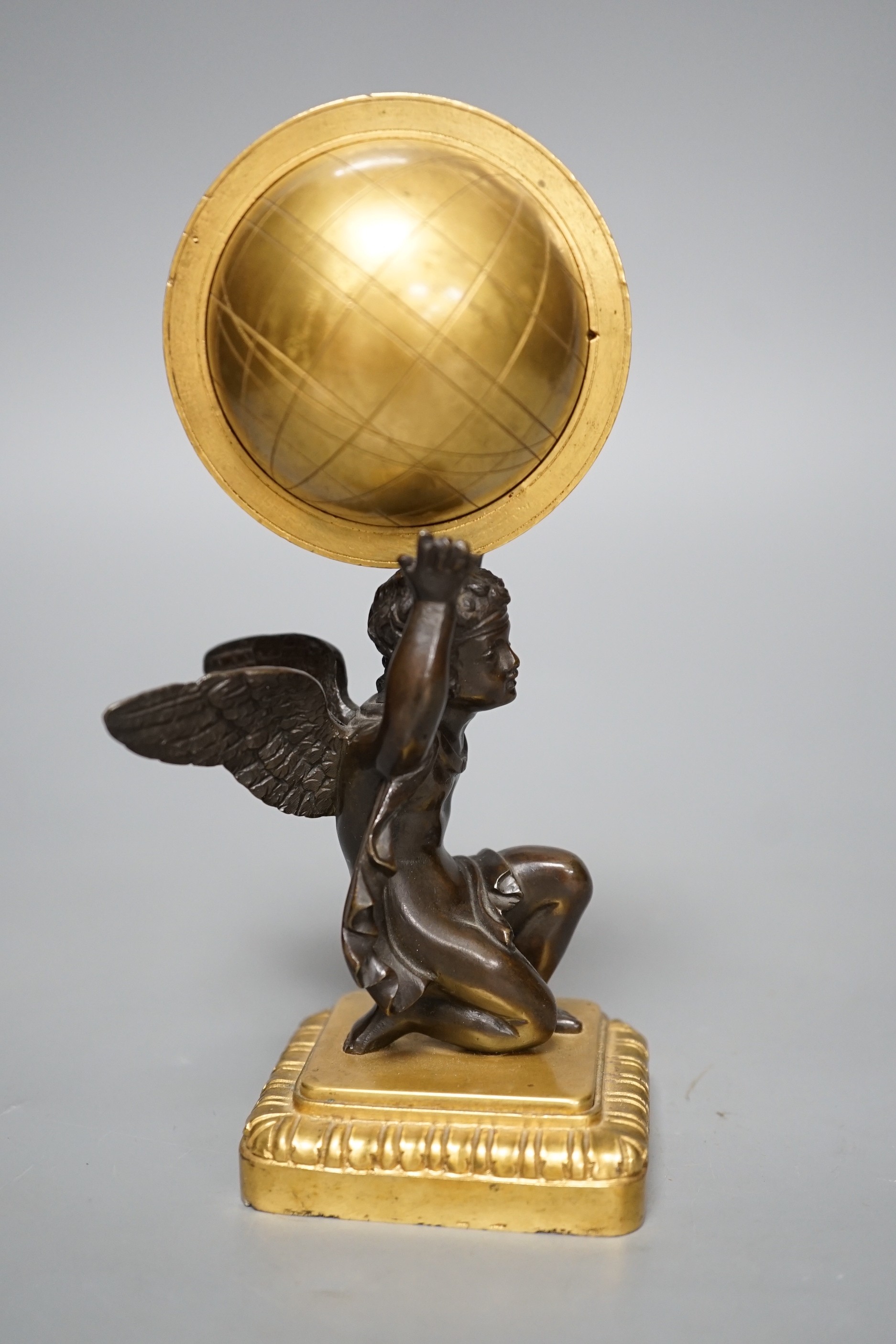 A late 19th century bronze and ormolu model of a cherub supporting a globe, 16cm